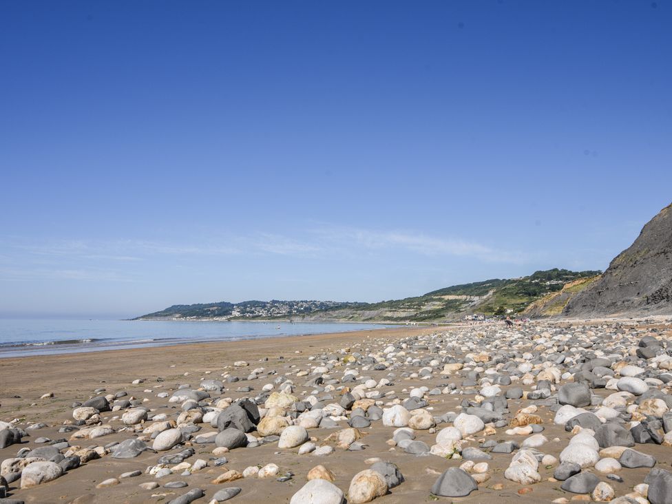 A beach with pebbles and water at St Helena in Charmouth