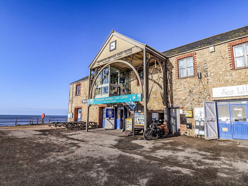 A coast center building with seating and a motorcycle at St Helena in Charmouth