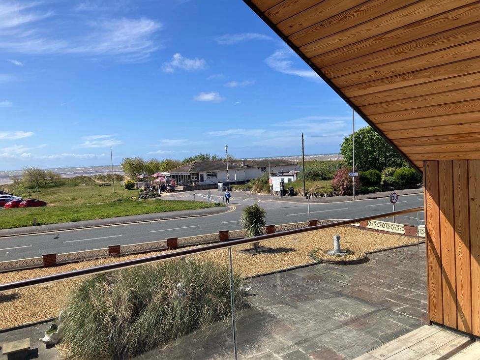 A view of the sea and a road with a building at Sea La Vie in Lytham St. Annes
