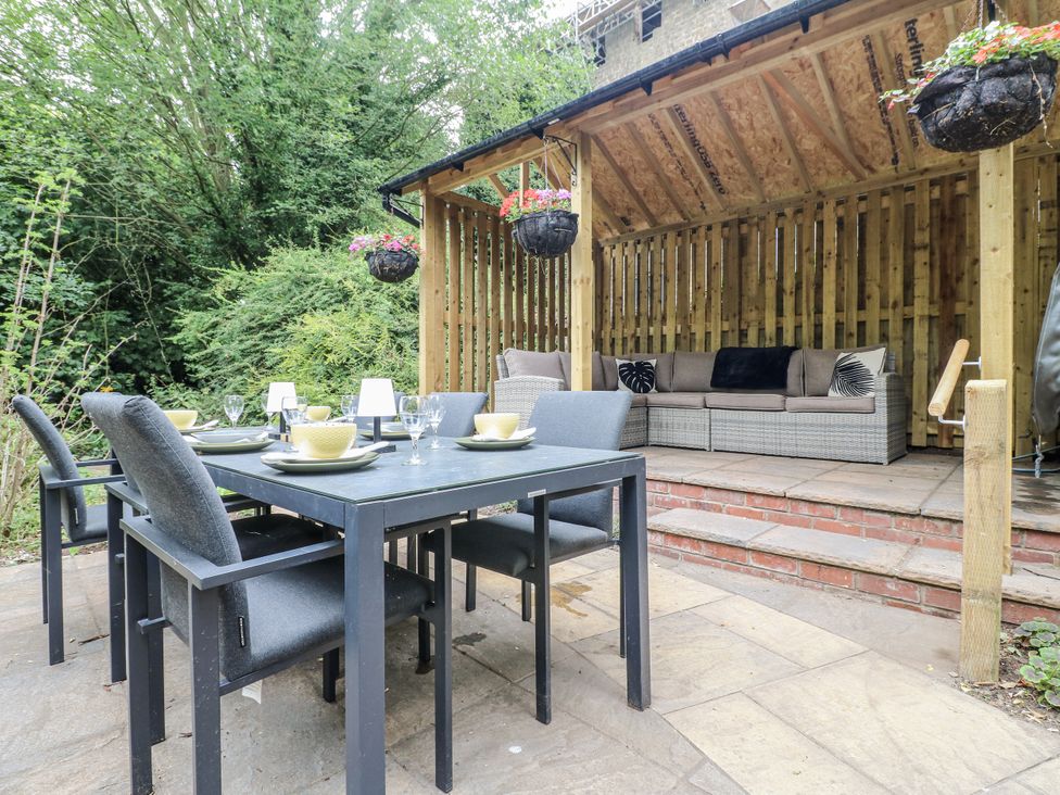 An outdoor dining area with a table and chairs at Mill View Duplex in Cuckney