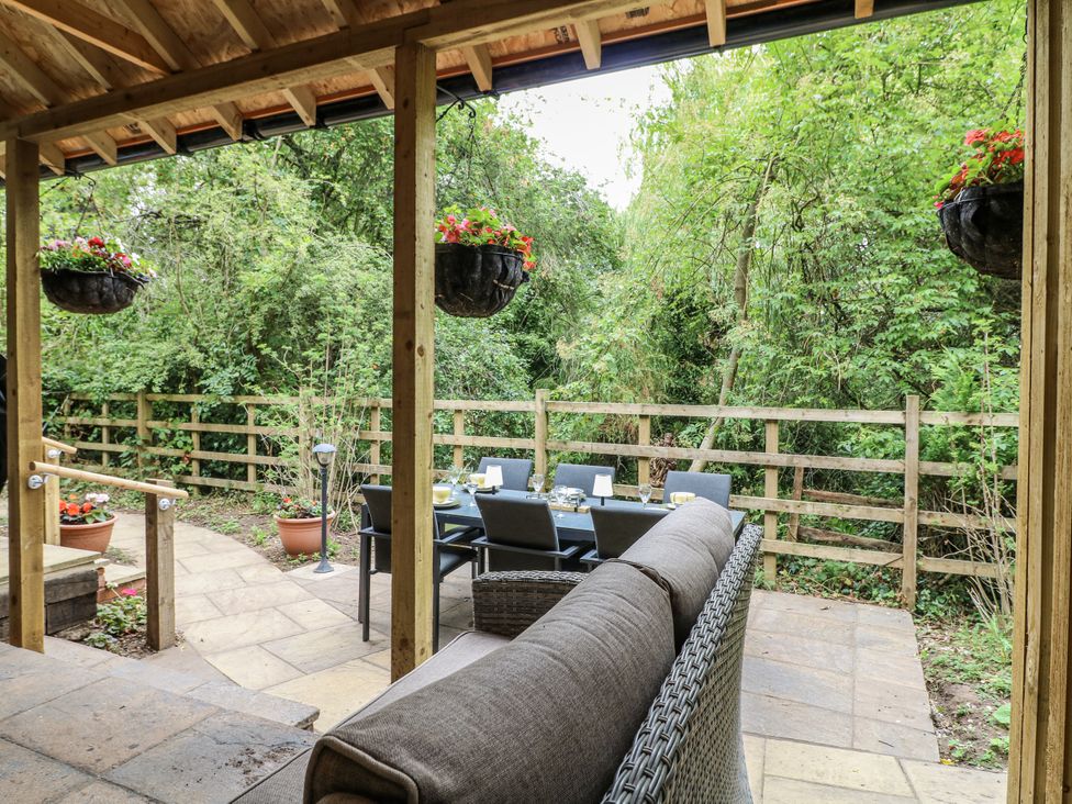 An outdoor dining area with a table and chairs at Mill View Duplex in Cuckney