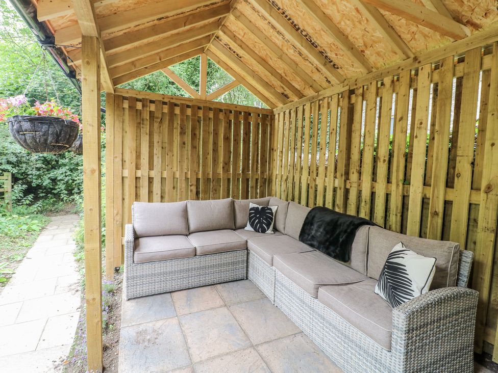 A seating area with a sofa and floor tiles at Mill View Duplex in Cuckney