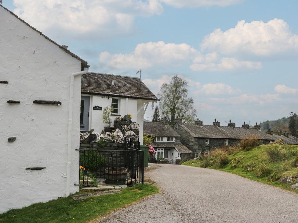A street scene with buildings and a road at Woodloft Cottage Elterwater near Chapel Stile