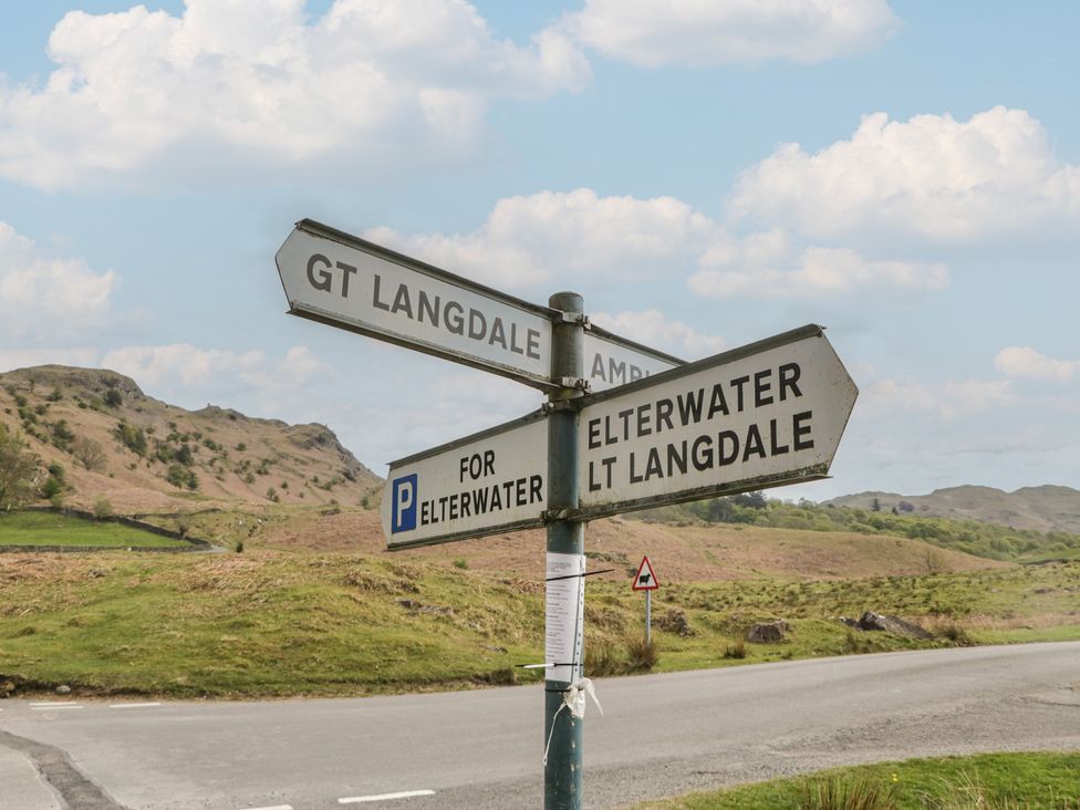 A signpost indicating directions to GT Langdale, Elterwater, and LT Langdale in Elterwater near Chapel Stile