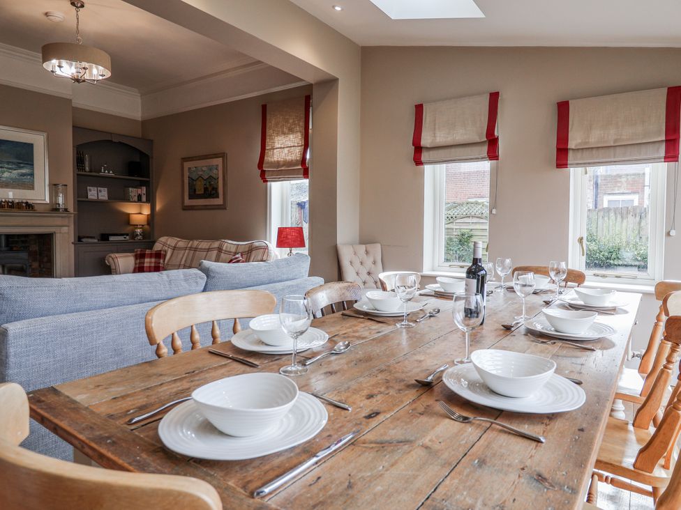 A dining room with a table set for dinner at Holly Lodge in Aldeburgh