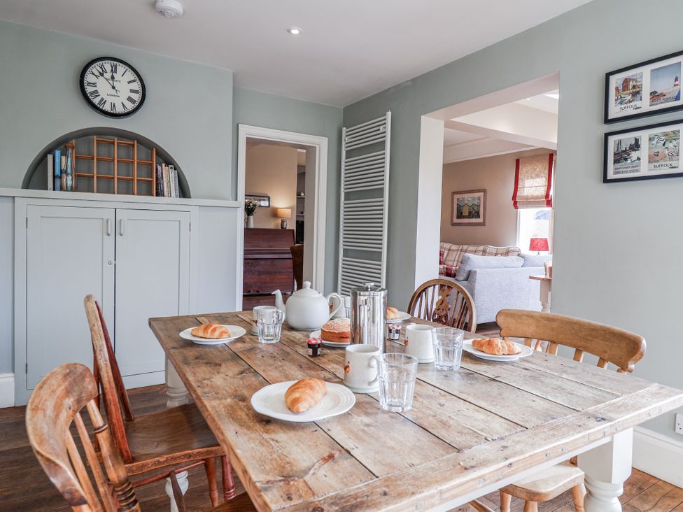 A dining room with a wooden table and chairs at Holly Lodge in Aldeburgh