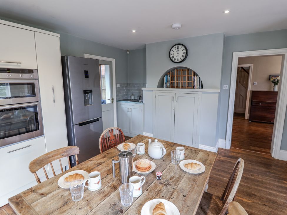 A kitchen with a dining table set for breakfast at Holly Lodge in Aldeburgh