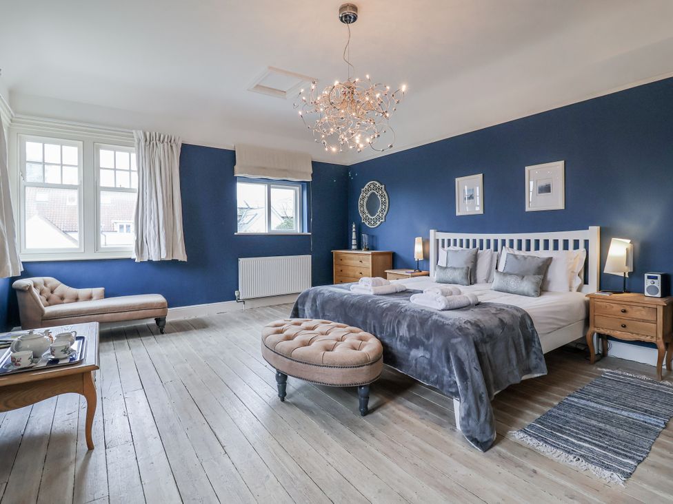 A bedroom with a bed and bedside tables at Holly Lodge in Aldeburgh