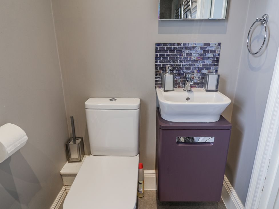 A bathroom with a toilet and sink at Holly Lodge in Aldeburgh