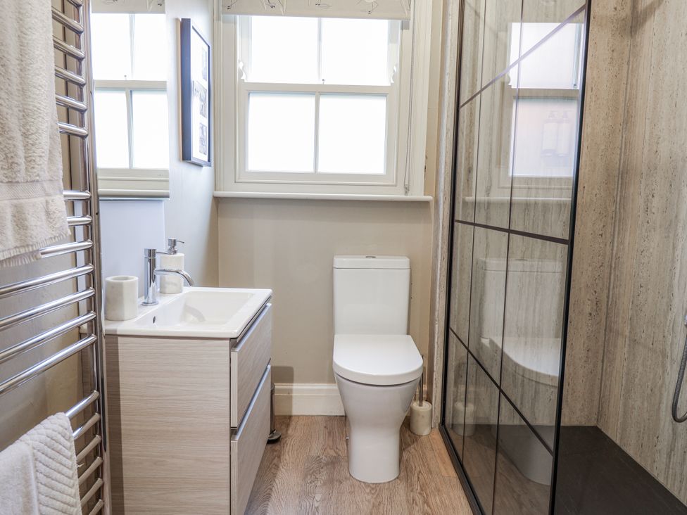 A bathroom with a shower, sink, and toilet at Holly Lodge in Aldeburgh