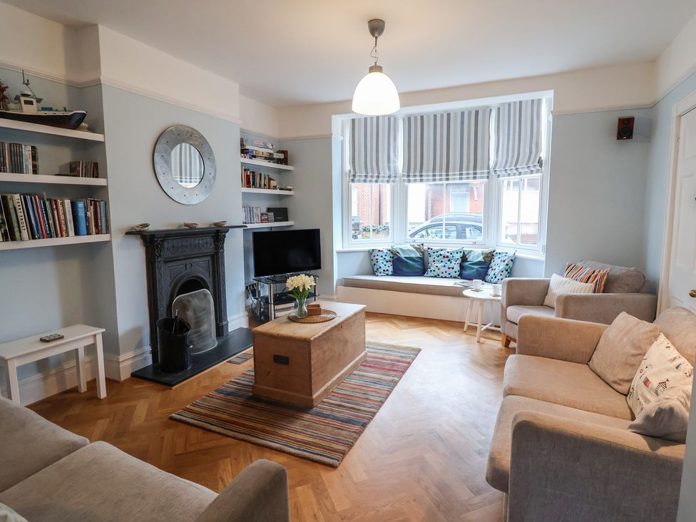 A living room with a television and fireplace at Lavender House, Aldeburgh