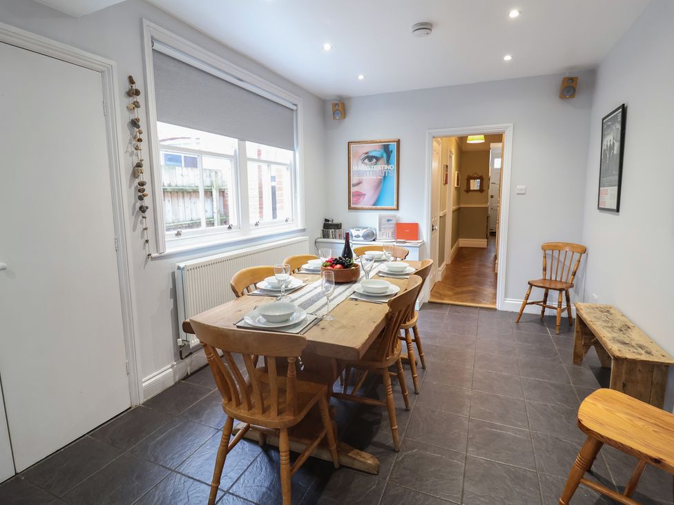 A dining room with a table set for a meal at Lavender House, Aldeburgh