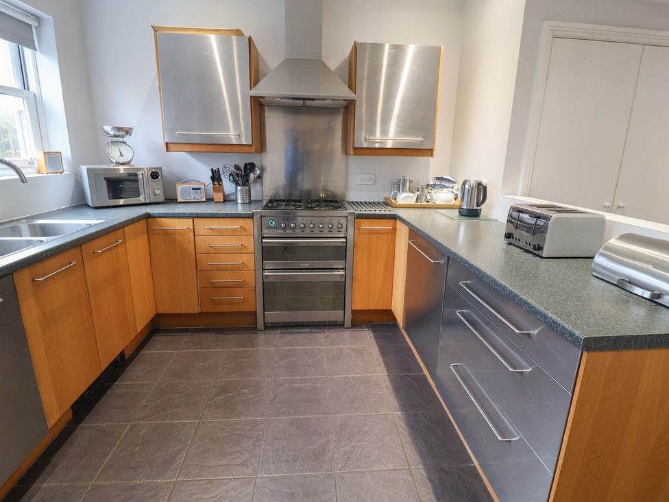 A kitchen with a stove and various appliances at Lavender House, Aldeburgh