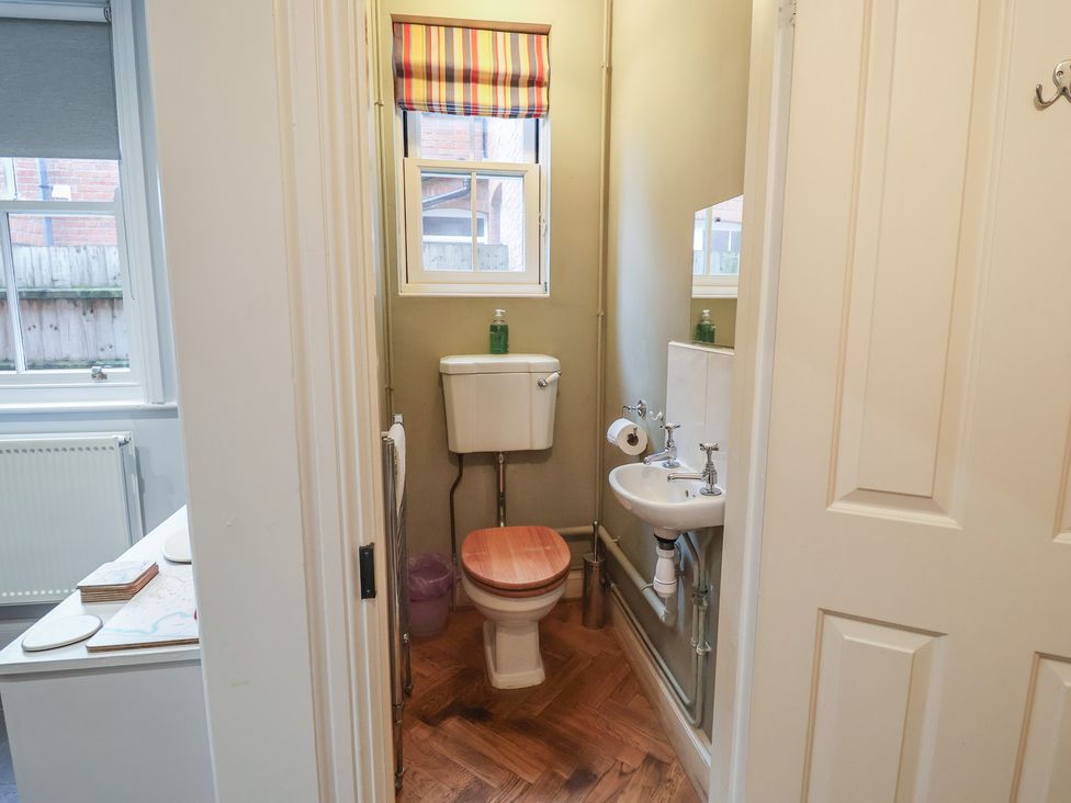 A bathroom with a toilet and sink at Lavender House, Aldeburgh