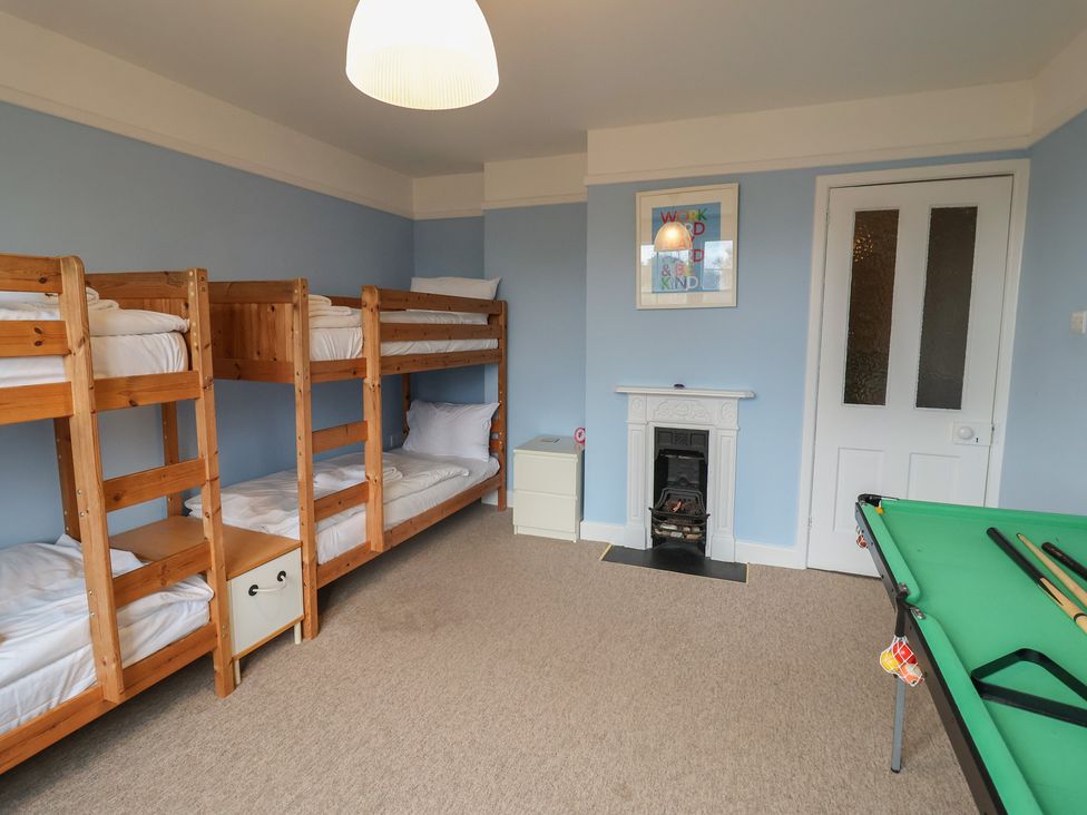A bedroom with bunk beds and a pool table at Lavender House, Aldeburgh