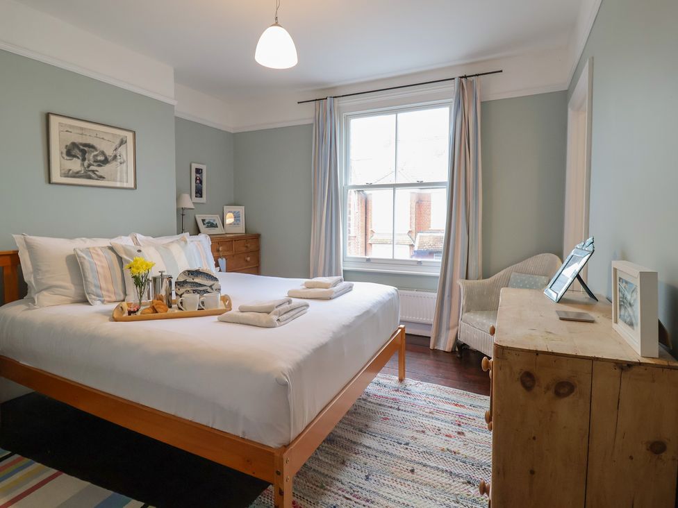 A bedroom with a bed and a table at Lavender House, Aldeburgh