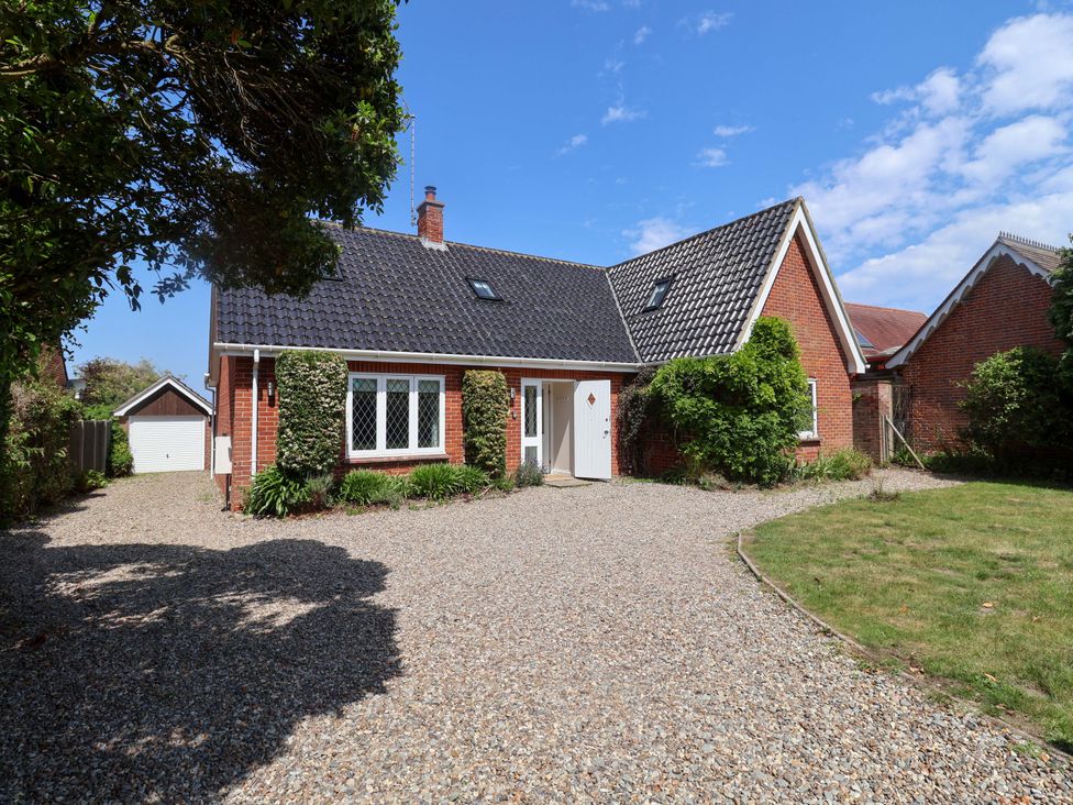 A house with a gravel driveway and garden at Seadrift in Dunwich Near Westleton