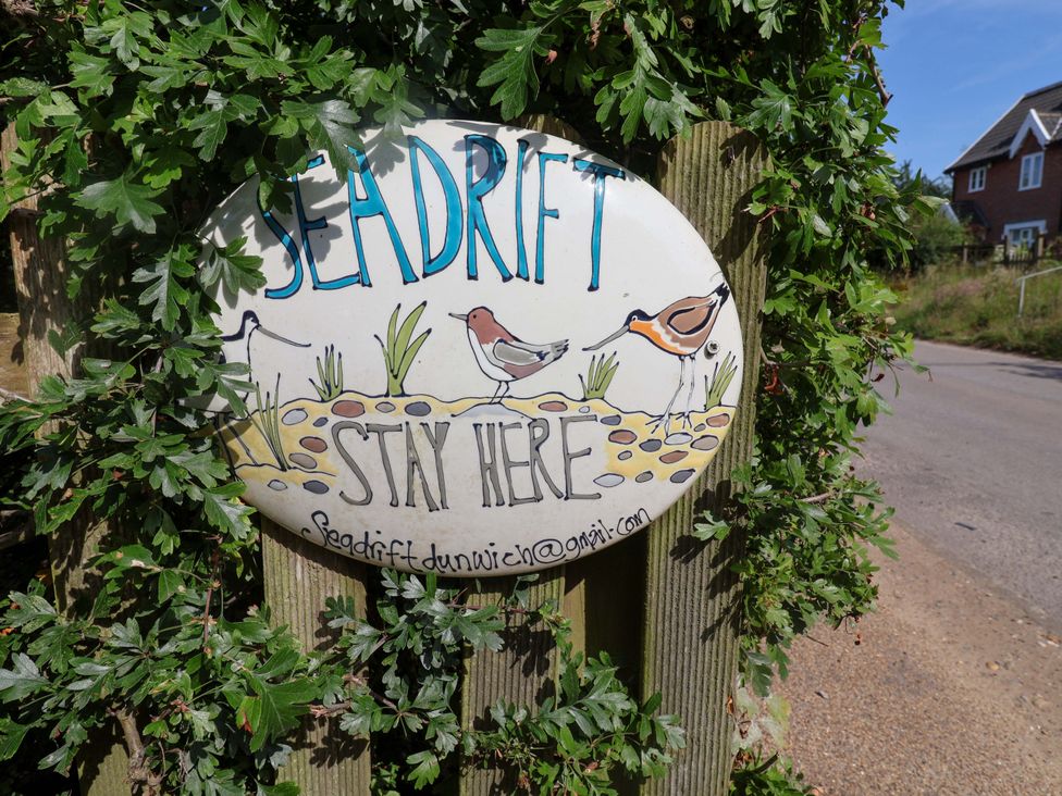 A sign with the text Seadrift Stay Here and illustrations of birds at Seadrift Dunwich Near Westleton