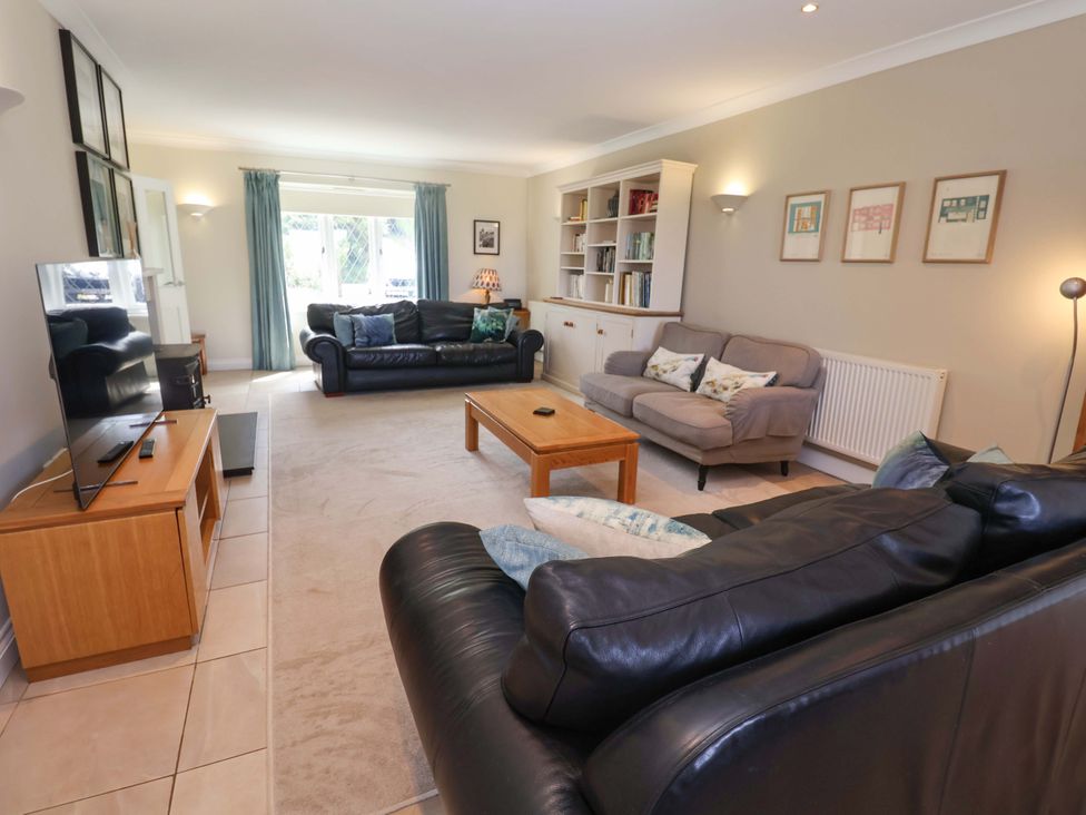 A living room with seating and a television at Seadrift in Dunwich Near Westleton