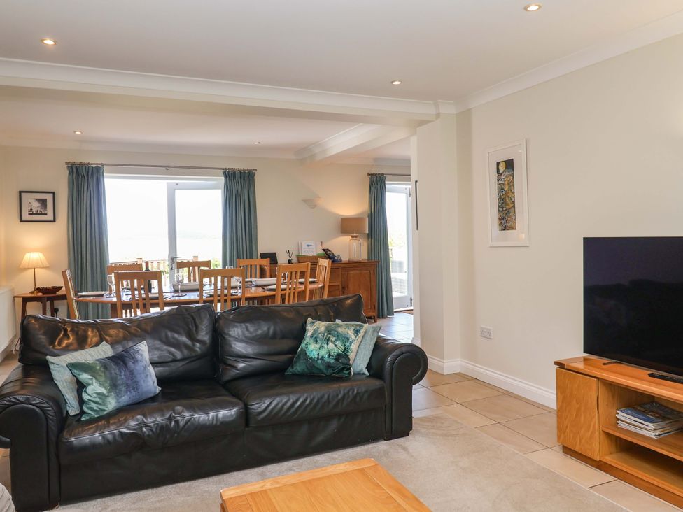 A living room with a sofa and dining area at Seadrift in Dunwich Near Westleton