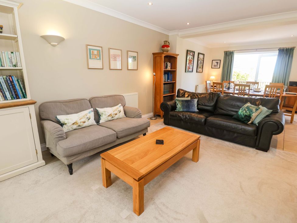 A living room with seating arrangements and a dining area at Seadrift Dunwich Near Westleton