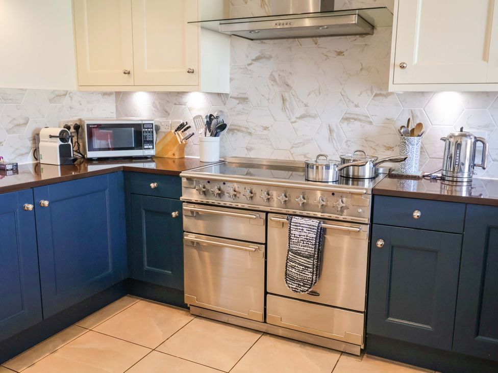 A kitchen with a stove and microwave at Seadrift Dunwich Near Westleton