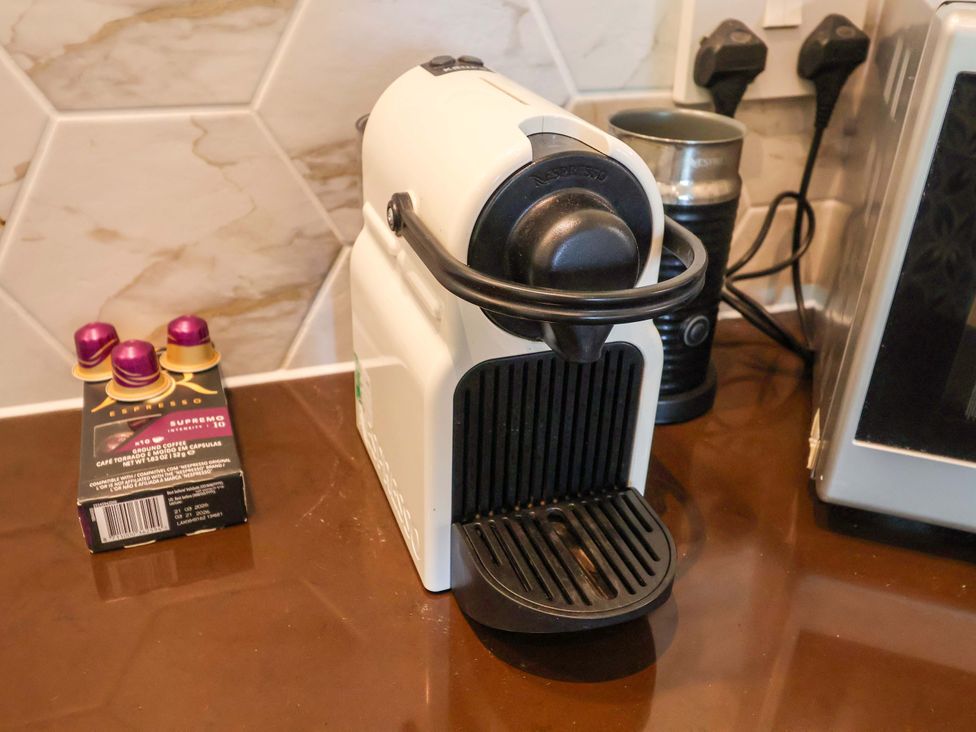A coffee machine and coffee capsules on a countertop at Seadrift Dunwich Near Westleton