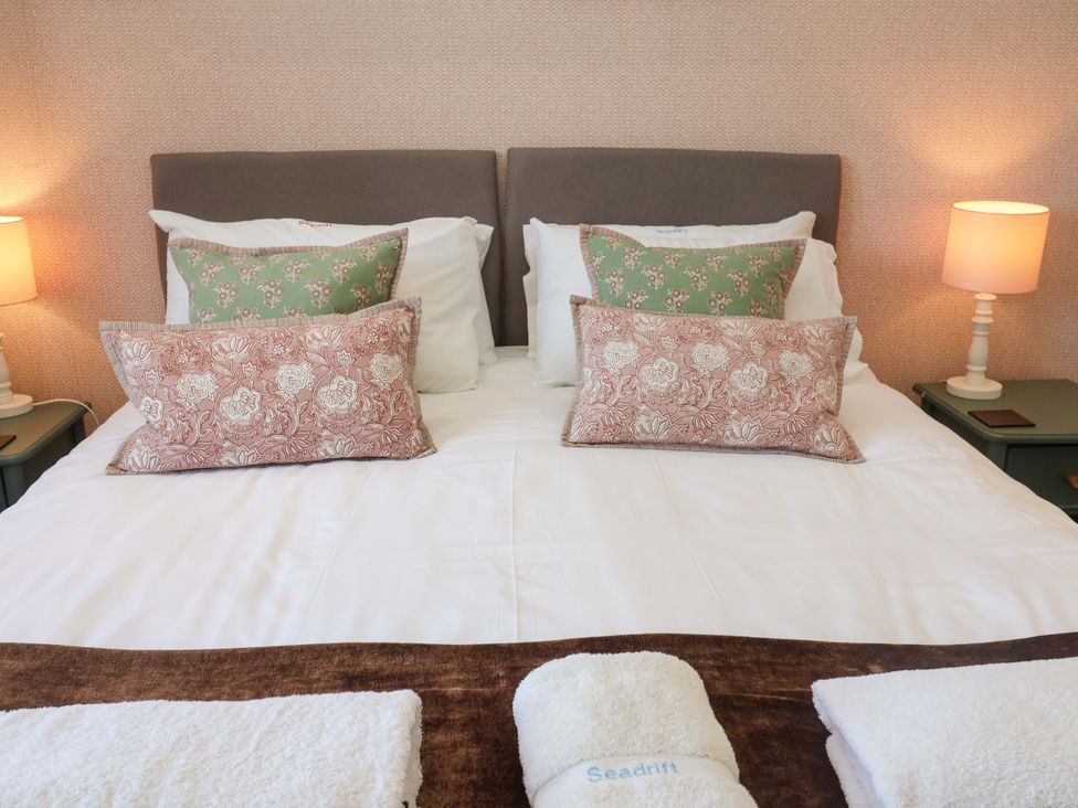 A bedroom with a double bed and bedside lamps at Seadrift Dunwich Near Westleton