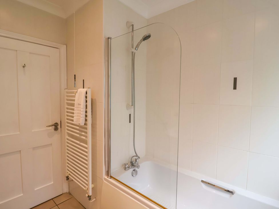 A bathroom with a bathtub and shower at Seadrift Dunwich Near Westleton