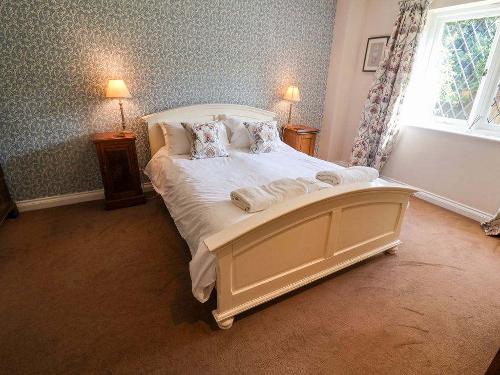 A bedroom with a bed and bedside tables at Seadrift in Dunwich Near Westleton