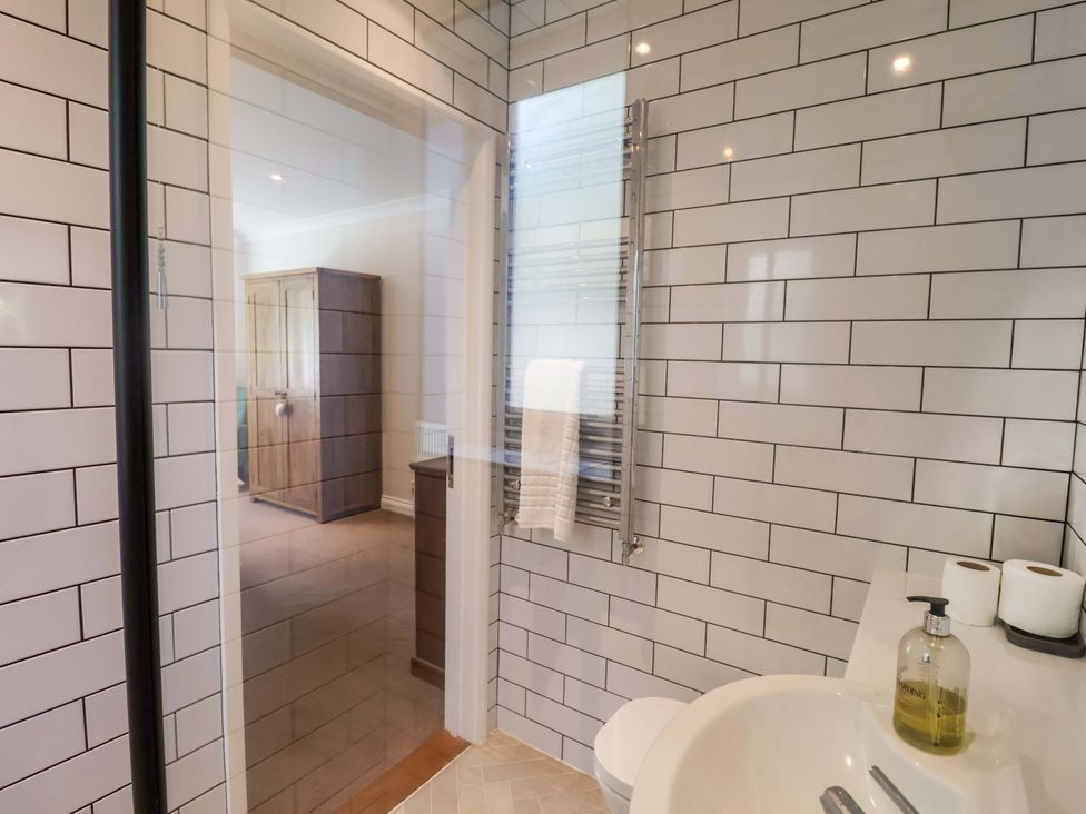 A bathroom with a shower and sink at Seadrift Dunwich Near Westleton