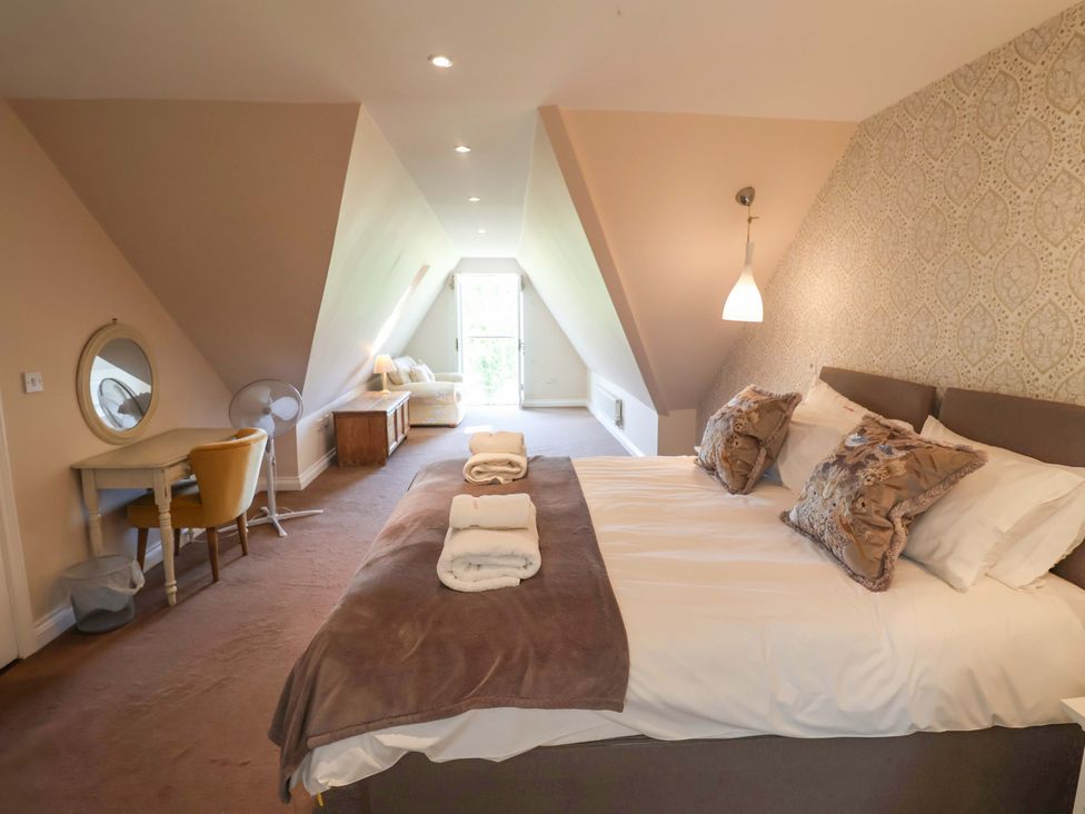 A bedroom with a bed and a dresser at Seadrift Dunwich Near Westleton