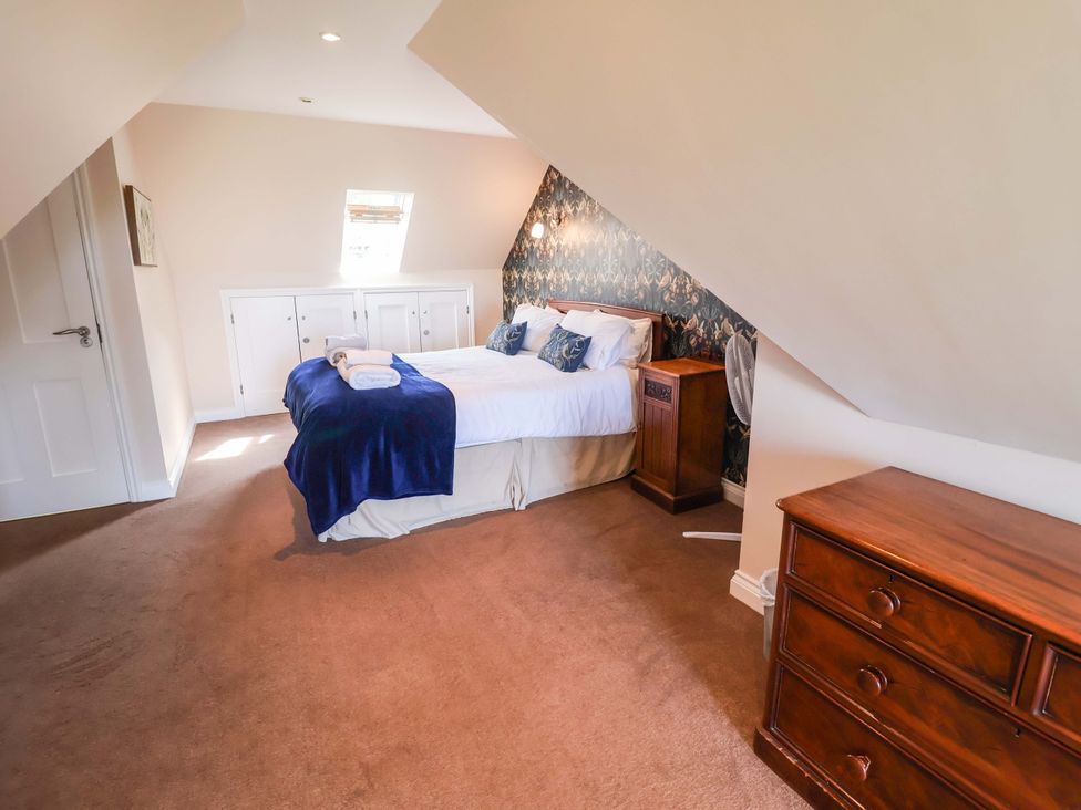 A bedroom with a bed and wardrobe at Seadrift Dunwich Near Westleton