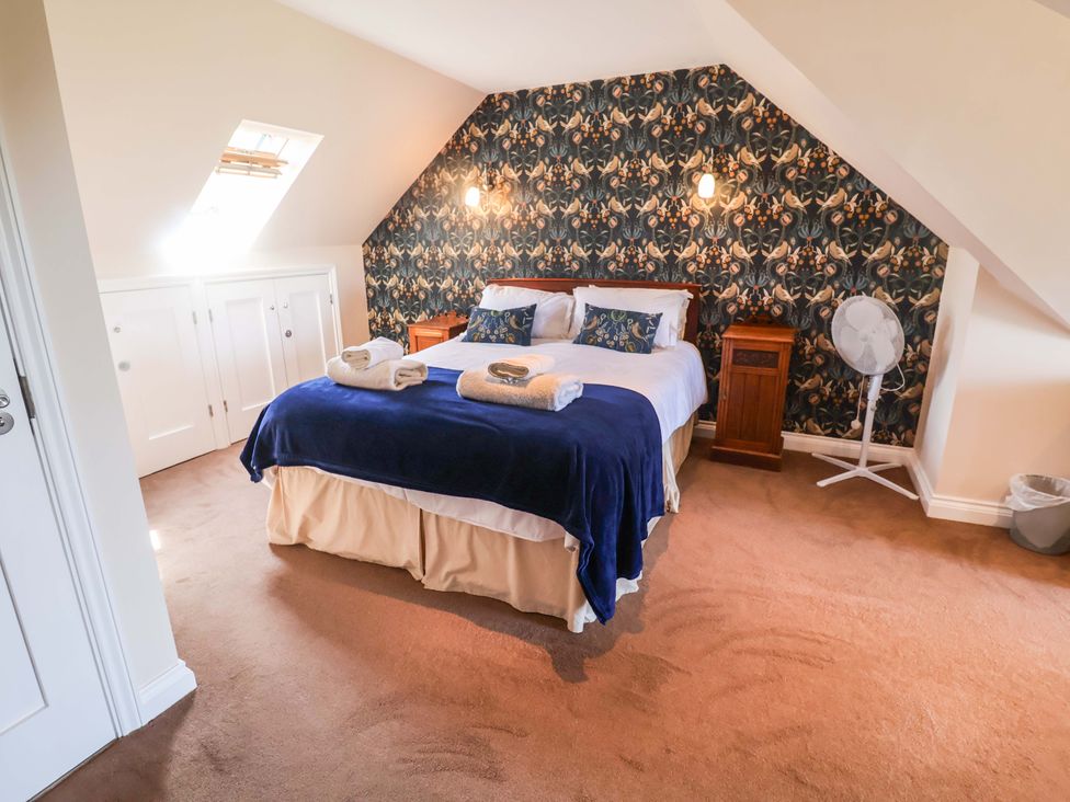 A bedroom with a bed and nightstand at Seadrift Dunwich Near Westleton