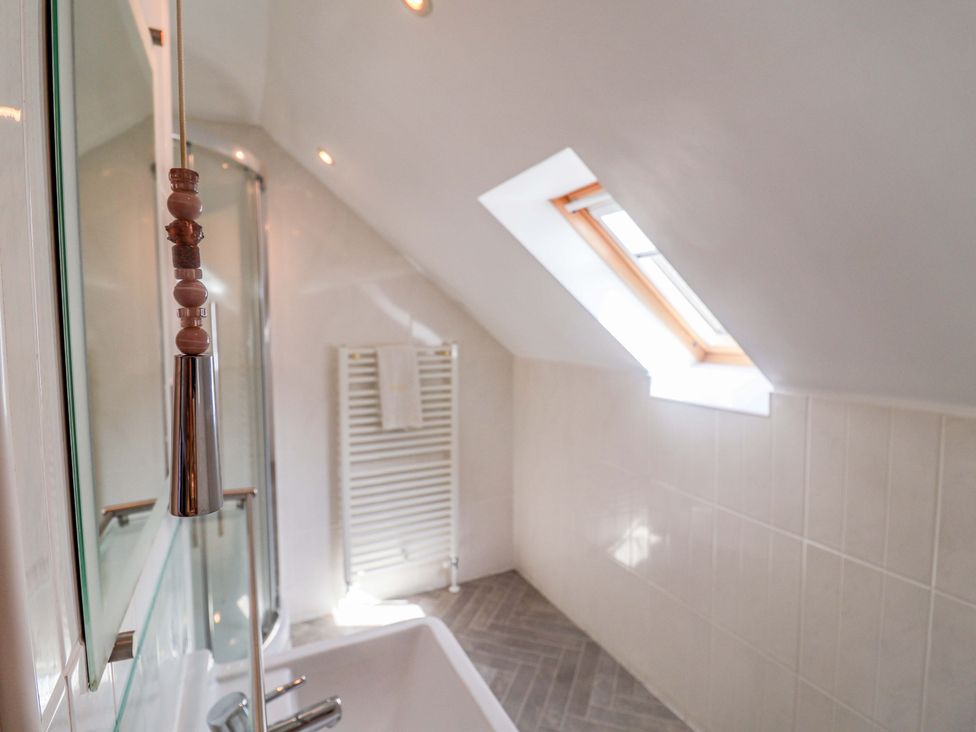 A bathroom with a bathtub and shower at Seadrift in Dunwich Near Westleton