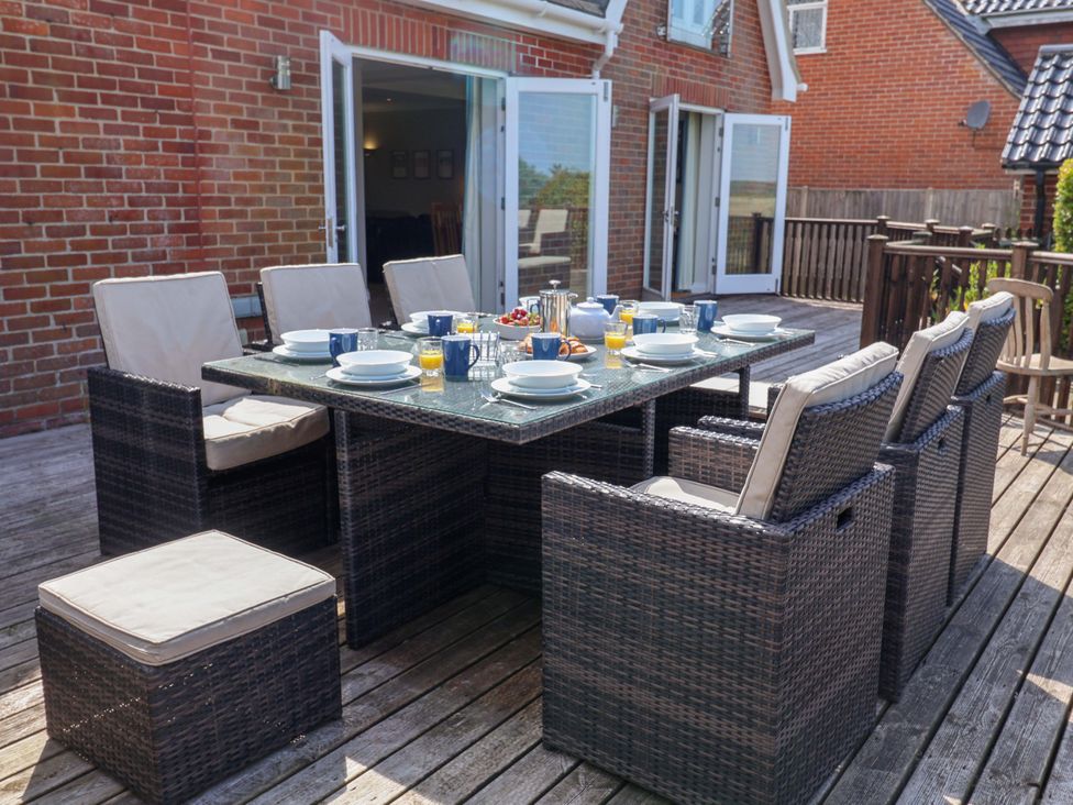 An outdoor dining area with a table set for breakfast at Seadrift Dunwich Near Westleton