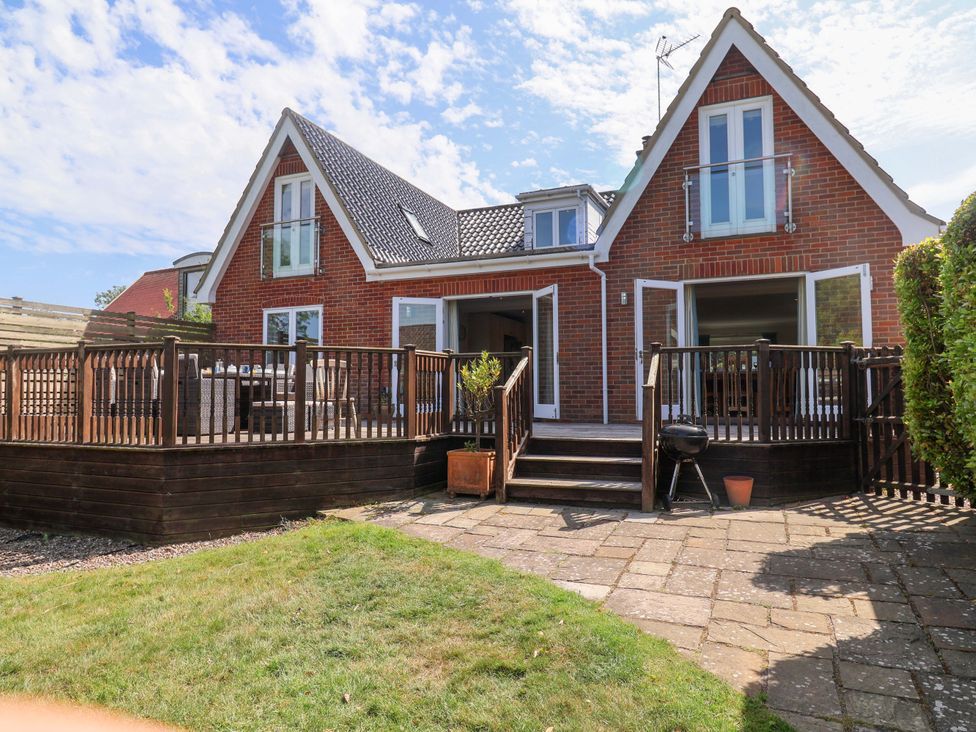 A house with a deck and stairs in the garden at Seadrift Dunwich Near Westleton