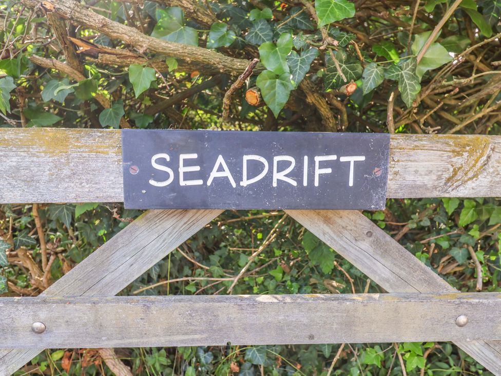 A sign on a gate with the name Seadrift Dunwich Near Westleton