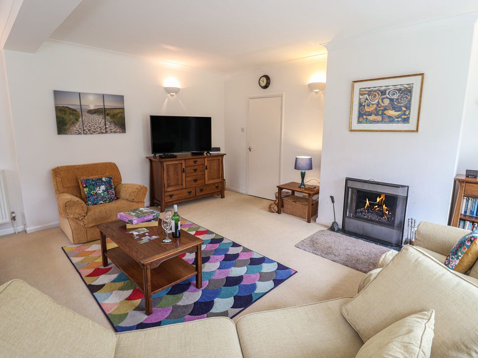 A living room with a sofa a chair and a coffee table at Rippleway, Walberswick