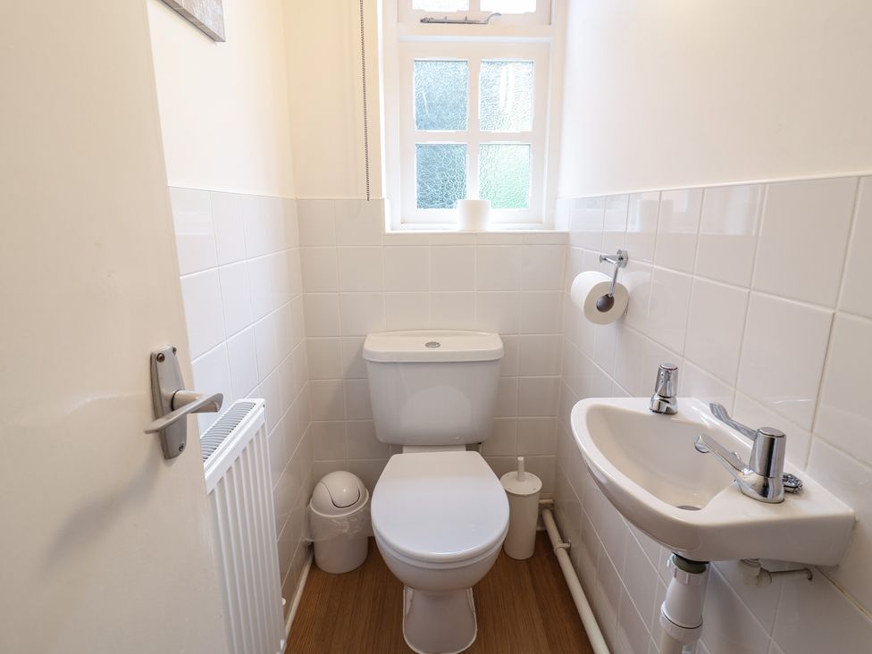 A bathroom with a toilet and sink at Rippleway, Walberswick