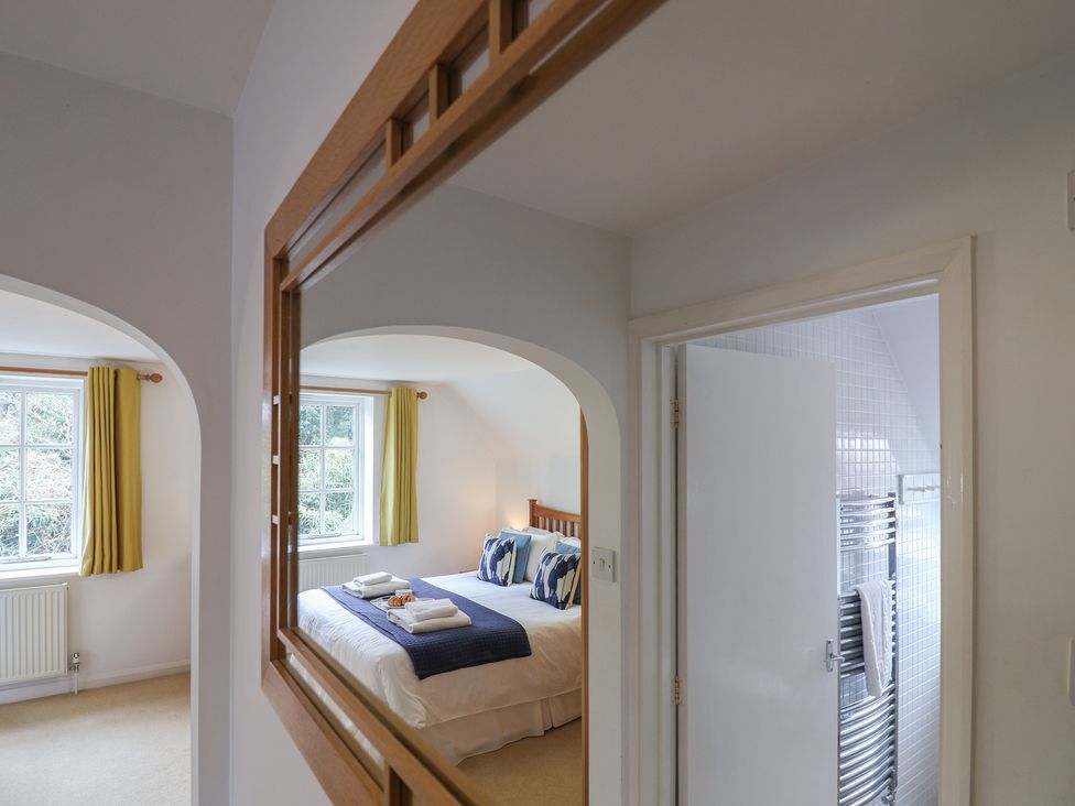 A bedroom with a bed and window at Rippleway, Walberswick