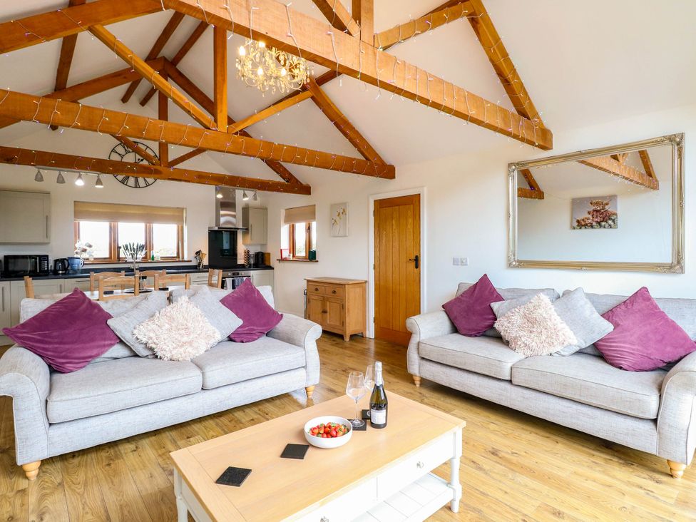 A living room with a sofa and coffee table at The Mulberry, nr Bungay