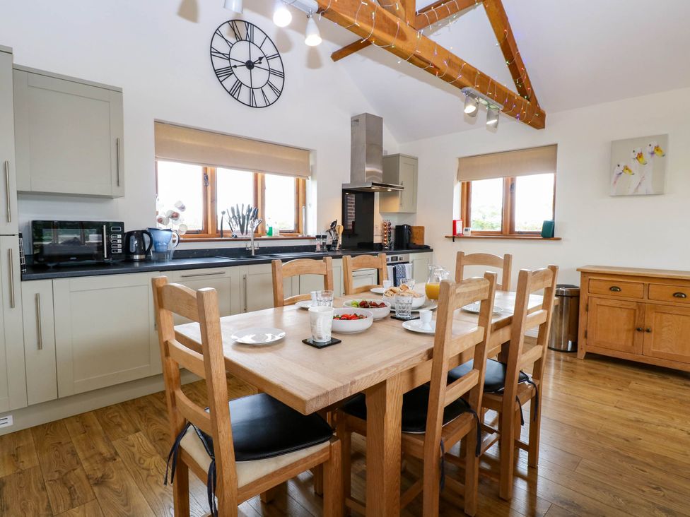 A kitchen with a dining table and chairs at The Mulberry, nr Bungay