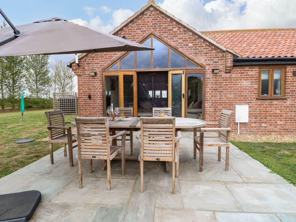 An outdoor dining area with a table and chairs at The Mulberry, nr Bungay