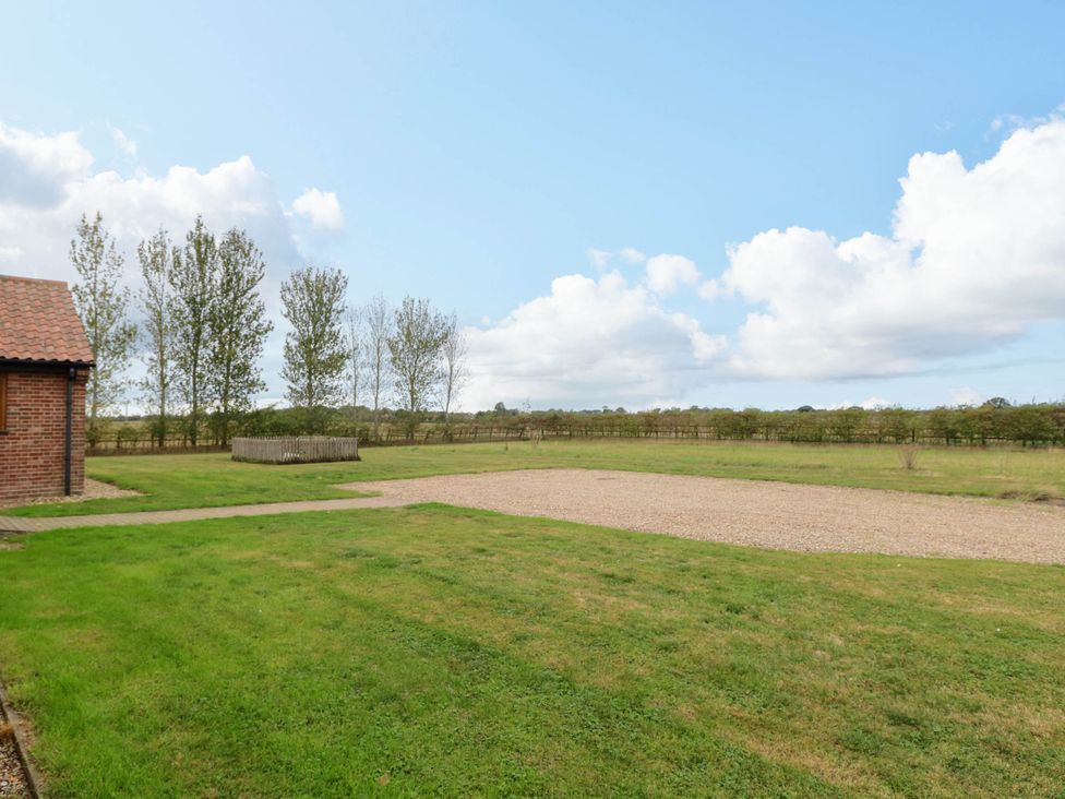 A garden with grass, a pathway, and a gravel area at The Mulberry, nr Bungay Bungay