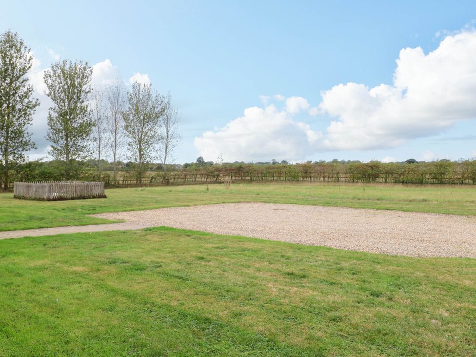An outdoor area with grass and a gravel path at The Mulberry, nr Bungay