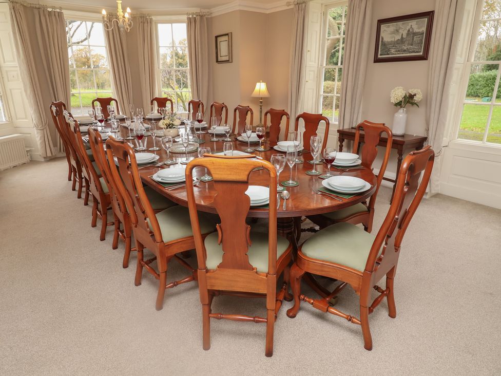 A dining room with a large table set for dinner at Henstead Hall Henstead near Beccles