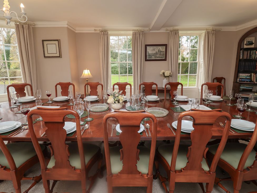 A dining room with a large table and chairs at Henstead Hall in Henstead near Beccles