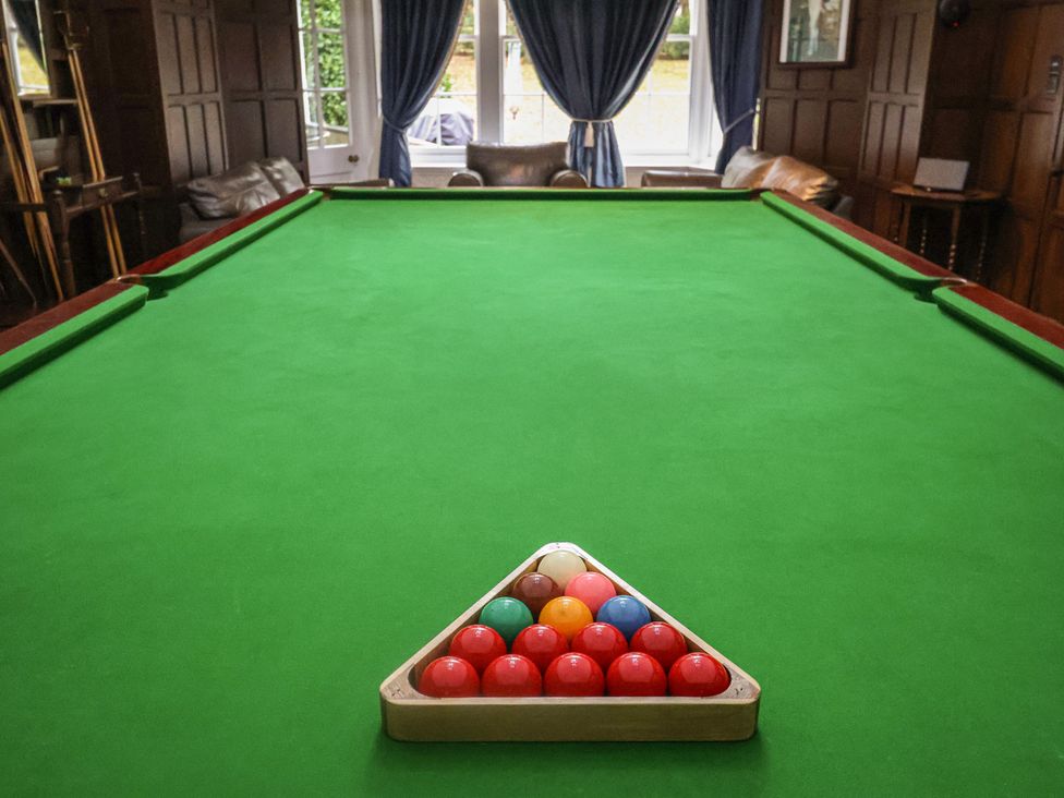 A pool table with billiard balls arranged at Henstead Hall, Henstead near Beccles