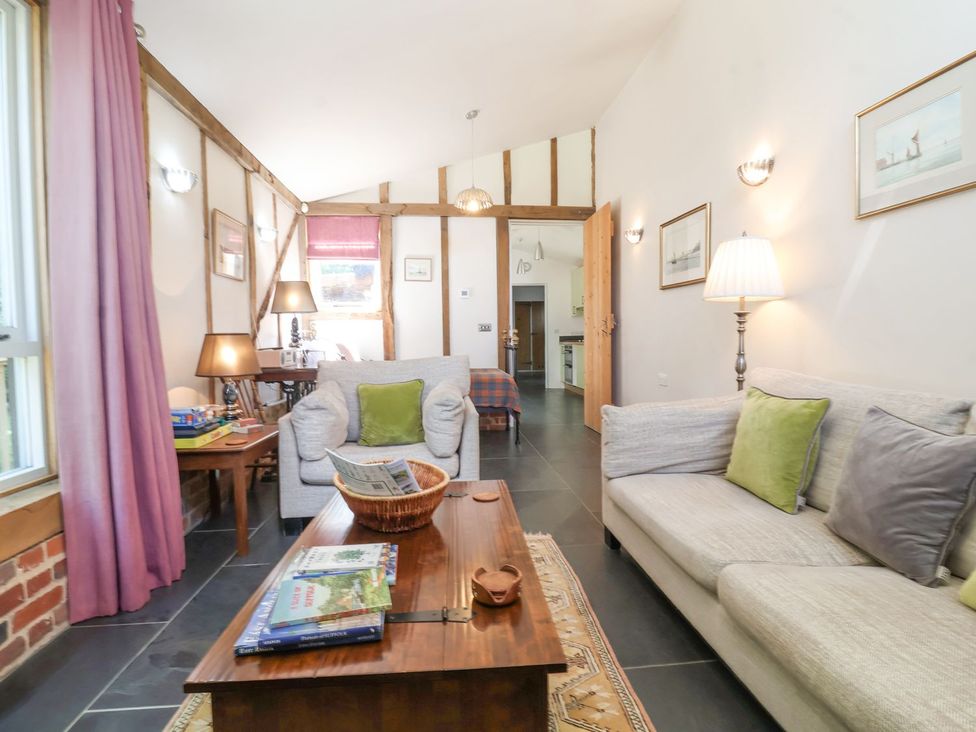 A living room with a sofa and coffee table at Yew Tree Farm Barn and Stable Framlingham
